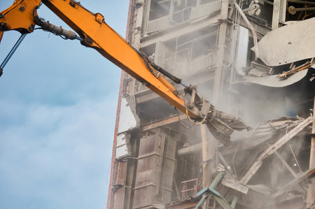 Destroying of old industrial building by excavator destroyerの写真素材