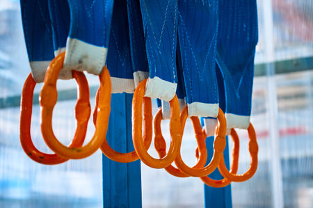 Rigging equipment with textile strops hangs on rack hooksの写真素材