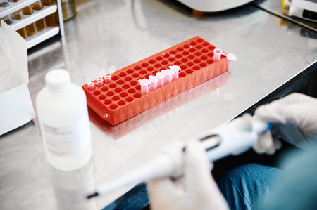 Technician works investigating analysis sample in test tubesの写真素材