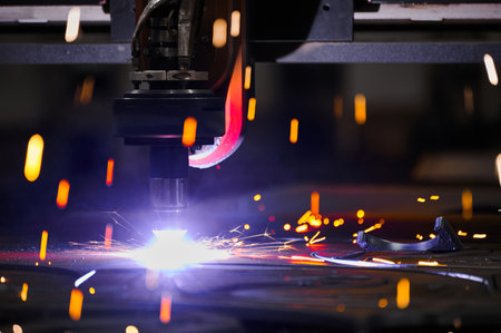 Bright flame sparks fly during plasma cutting out of detailsの写真素材