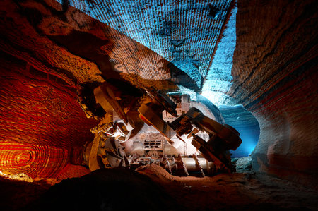 Illuminated mining drilling machine in salt quarry tunnelの写真素材