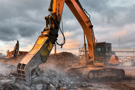 Excavator with concrete crusher at demolition siteの写真素材