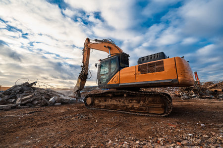 Excavator with hydraulic press breaks concrete leftoversの写真素材