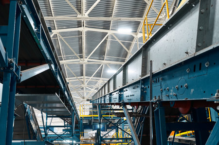 Conveyor carries trash pieces in recycling plant workshopの写真素材