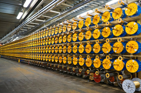 Bobbins coil thin wire to reinforce tires in plant workshop