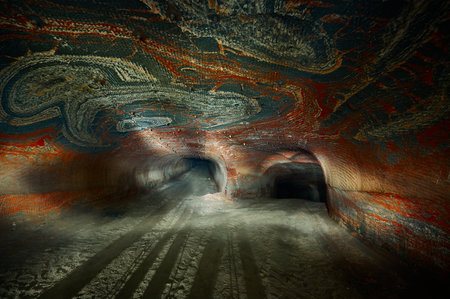 Outgoing tunnel of salt quarry with red patterns on wallsの写真素材