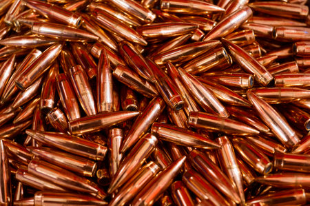 Copper metal bullets pile for weapons as backgroundの写真素材