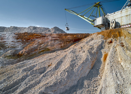 Walking excavator takes chalk with bucket in open quarryの写真素材
