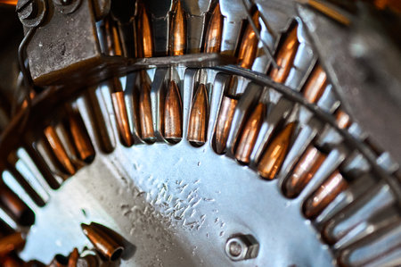 Pile of orange bullets and turning wheel at production lineの写真素材