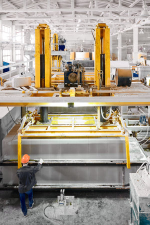 Workers in factory shop for production of concrete blocks