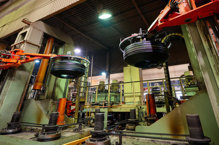 Robotic arms hold new car tires in production plant shopの写真素材