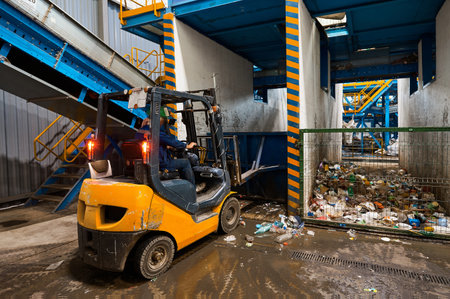 The bulldozer loader compacts the sorted waste in the storage bin. Separate sorting of household...