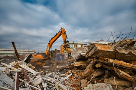 Excavator destroyer with hydraulic scissors cuts concreteの写真素材