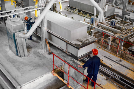 Workers in factory shop for production of concrete blocks