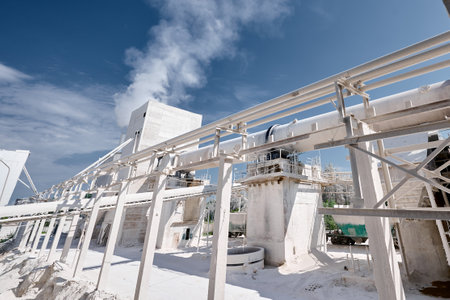 Long tubular rotary furnace at silica factory on sunny day
