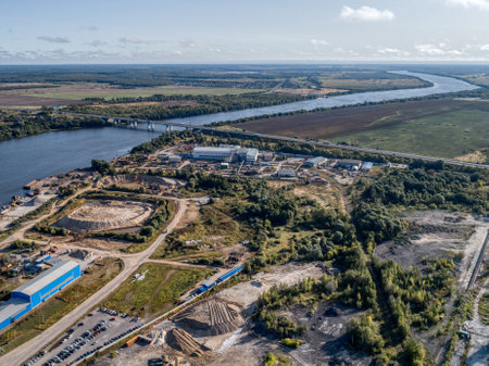 Huge factory area with construction site near river waterの写真素材