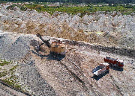 Tip trucks and shovel mining excavatorin chalk quarry