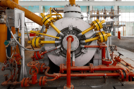 Powerful industrial pump operating within a chemical plants facility during daylight hours...