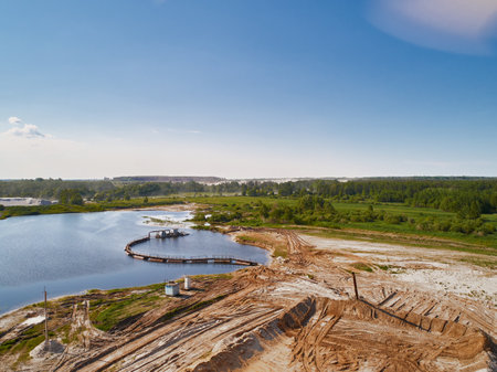 Suction tube dredger in sand mining quarry on sunny dayの写真素材