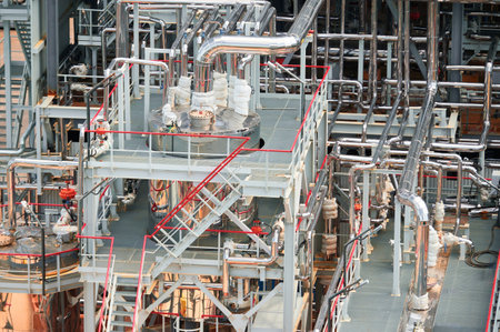 Detailed view of pipelines and structures in a chemical processing plant in operation, showcasing...
