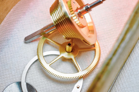 Intricate details of clockwork components featuring cogwheels and gears illuminated softly by warm...