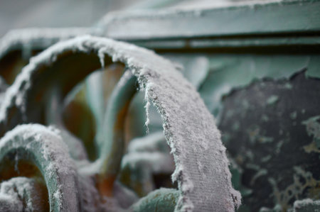 Frost-covered fragments of textile machines reveal stories of vintage industry in a forgotten workshopの写真素材