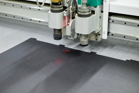 Precision cutting on a wide format CNC plotter for intricate designs in a modern workshopの写真素材