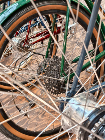 Bicycle gears and spokes create a dynamic visual in a cycling workshop filled with vibrant colors and unique designsの写真素材