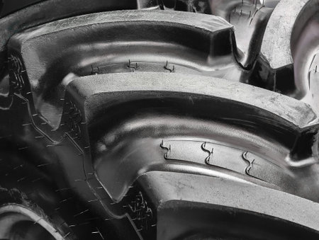 Wheels of agricultural machinery showcasing intricate tread patterns in a field setting during a sunny afternoonの写真素材