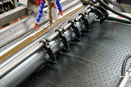 Innovative glue applicator in action at a manufacturing facility during daytime operations