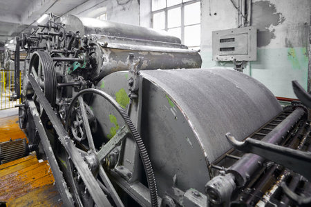Vintage carding machine illustrating early textile production techniques in an industrial settingの写真素材