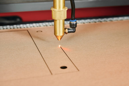 Precision laser cutting transforms cardboard sheets in a busy manufacturing environment at a box...