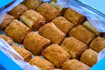 Delicious filled rolls displayed in a bakery box at a local bakery, showcasing a tempting variety of flavors and texturesの写真素材