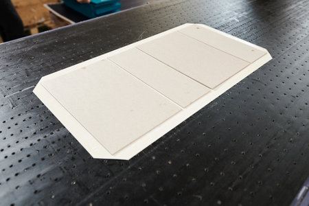 Innovative manufacturing process of decorative packaging box lid blanks on the production conveyor...
