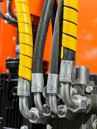 Exploring the intricacies of hydraulic connectors and hoses in industrial machineryの写真素材