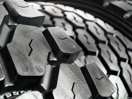Close-up view of heavy construction equipment wheels showcasing rugged tire tread patterns suitable for tough terrainの写真素材