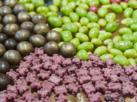 An array of colorful dragee candies inviting sweet indulgence and cheerful moments at a bustling candy marketの写真素材