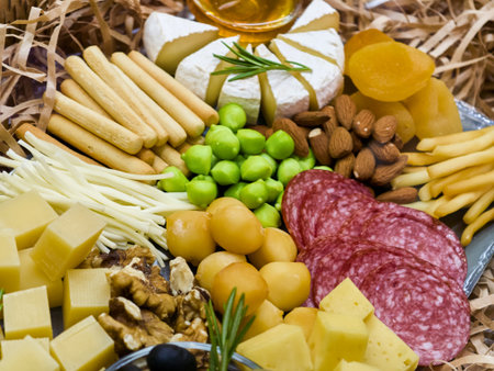Delightful spread of gourmet cheeses, charcuterie, and tasty accompaniments for a festive gathering or cozy celebrationの写真素材