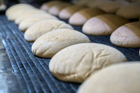 Farmhouse bran dough rising at bakery oven inlet during early morning preparation for bakingの写真素材