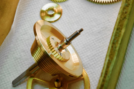 Intricate detail of a conical drum chronometer showcasing its fine craftsmanship and precision mechanics in a well-lit workshopの写真素材