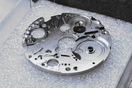 Intricate components of watch mechanisms showcased in a meticulous metalworking environment of a watch factoryの写真素材