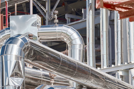 Industrial pipes and equipment at a chemical processing facility during daytime operationsの写真素材