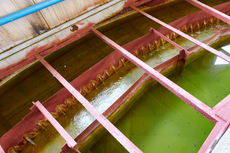 Industrial radial sedimentation tank clarifier operating at a water treatment facility during day hoursの写真素材