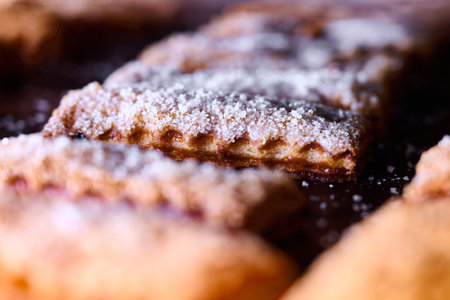 Delicious puff pastry cookies with a light and crumbly texture topped with sugar for a sweet treat at a cozy bakeryの写真素材
