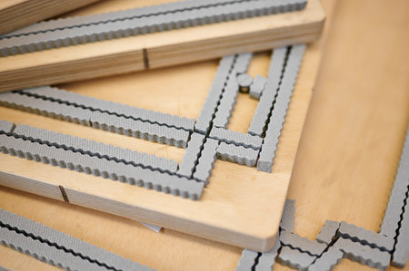 Innovative die cutting dies for precision cardboard box production in a vibrant workshop environmentの写真素材