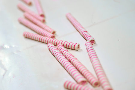 Crafting rolled wafer cones with sweet designs in a kitchen setting during the afternoon hoursの写真素材