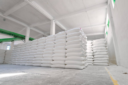 Flour sack storage facility filled with neatly stacked bags in a spacious environmentの写真素材