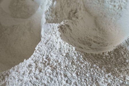 White wheat flour in a well-structured mound ready for baking or cooking in a home kitchen settingの写真素材