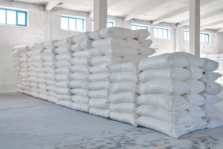 Warehouse storing large quantities of wheat flour bags ready for distribution in a clean and organized spaceの写真素材