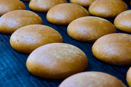 Freshly baked white-rye blend bread cooling at bakery oven outlet with a variety of mixed grain...
